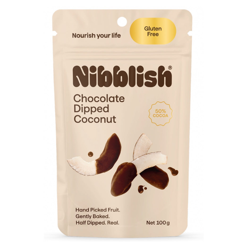 Nibblish Chocolate Dipped Coconut in a 100g stand-up pouch. The packaging is beige with brown text and graphics showing chocolate-dipped coconut halves, with a yellow 'Gluten Free' badge and '50% Cocoa' seal.