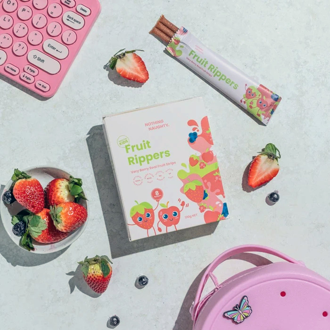 Fruit Rippers packaging with strawberries and a pink lunch box on a light surface