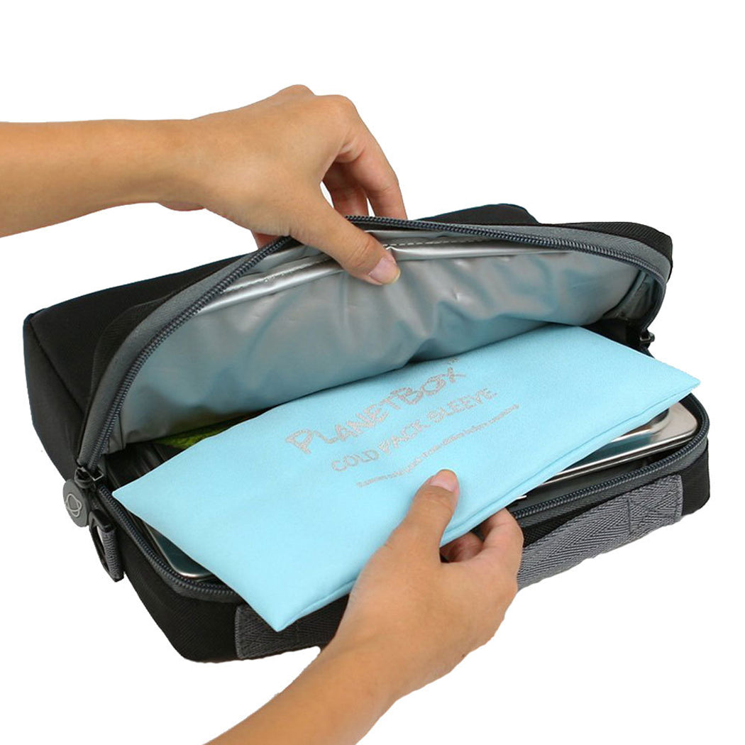 A black zippered organizer pouch with a silver interior, shown being opened by two hands. A light blue fabric sleeve labeled 'PurseBox' is partially pulled out.