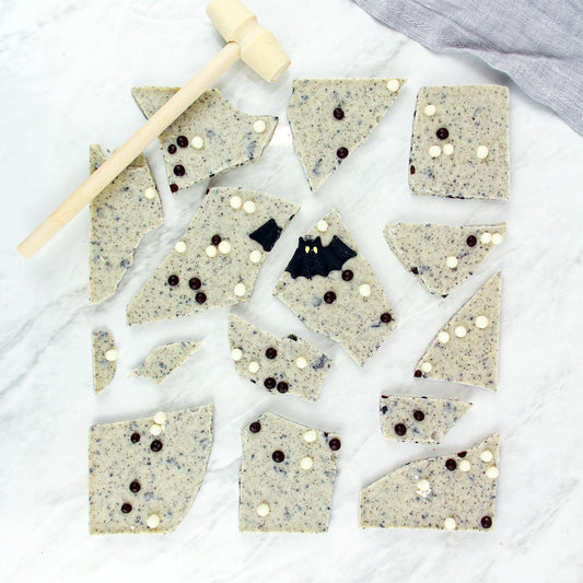 Biscuit pieces with chocolate chips on a white surface