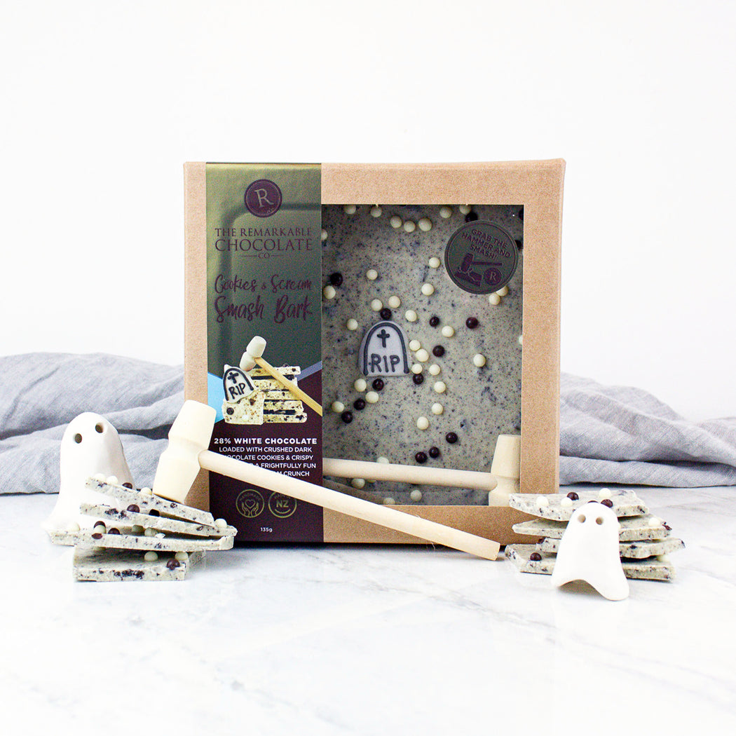 Halloween-themed chocolate bars with ghost decorations on a white surface.