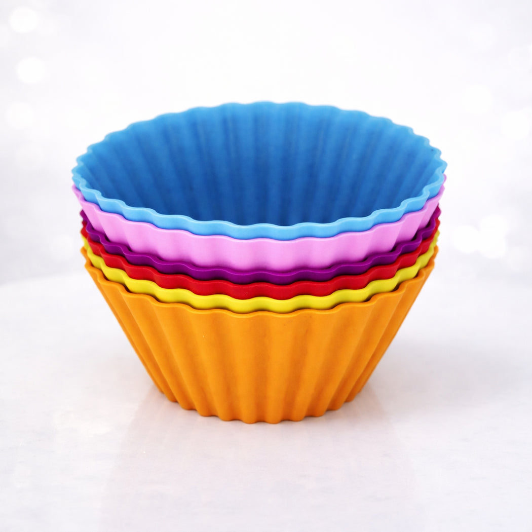 Stack of colorful silicone baking cups on a white background