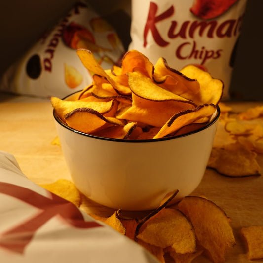 Bowl of chips with Kuma Chips packaging in the background