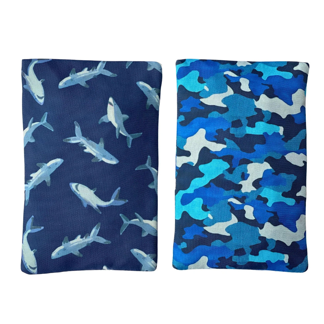 Two bean bags with shark pattern on one and blue camouflage pattern on the other, on a white background.